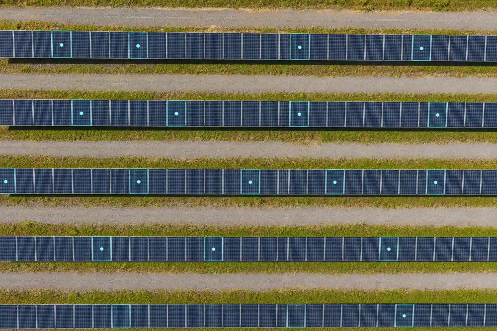 Top-down drone image of solar panels with AI detection markers showing how modules can be counted from above